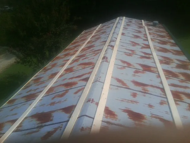 Rusted metal roof panels with new wood purlins before replacement — Storm Damage Roof Repair in Filer by Roofing Brothers