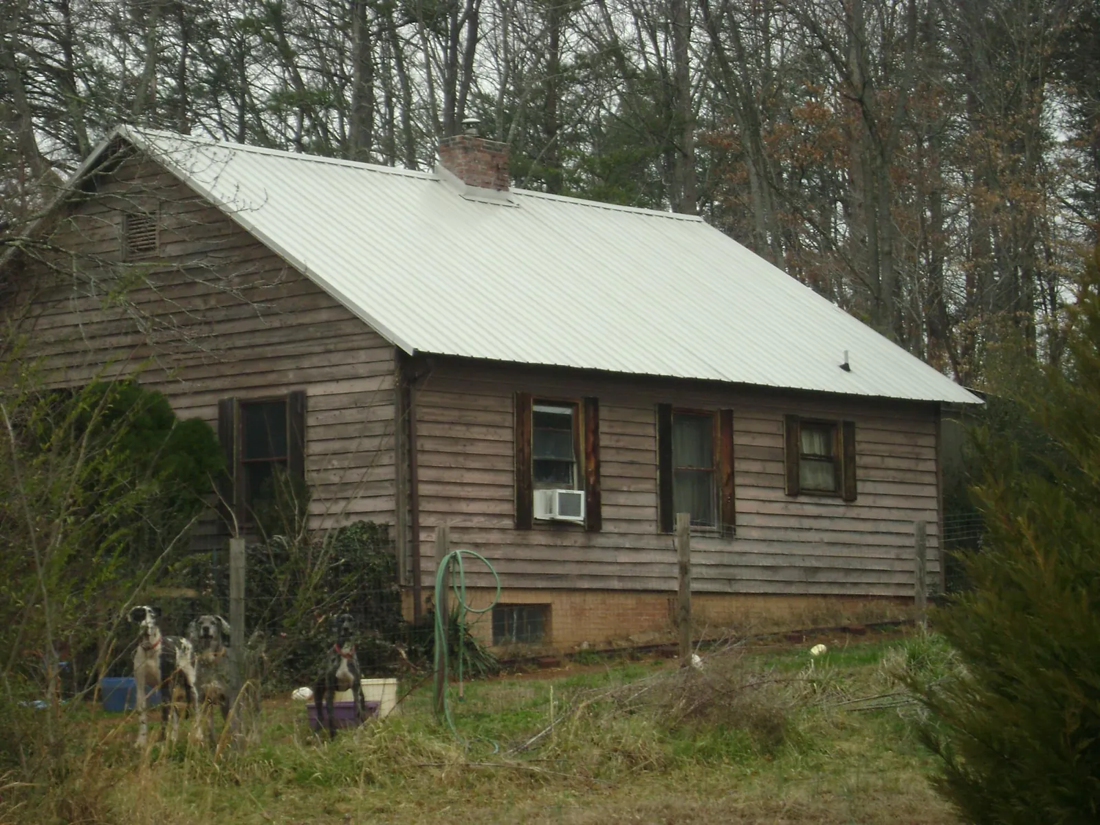 White metal roof on an old wood sided farmhouse, from a Metal Roof Installation job in Filer